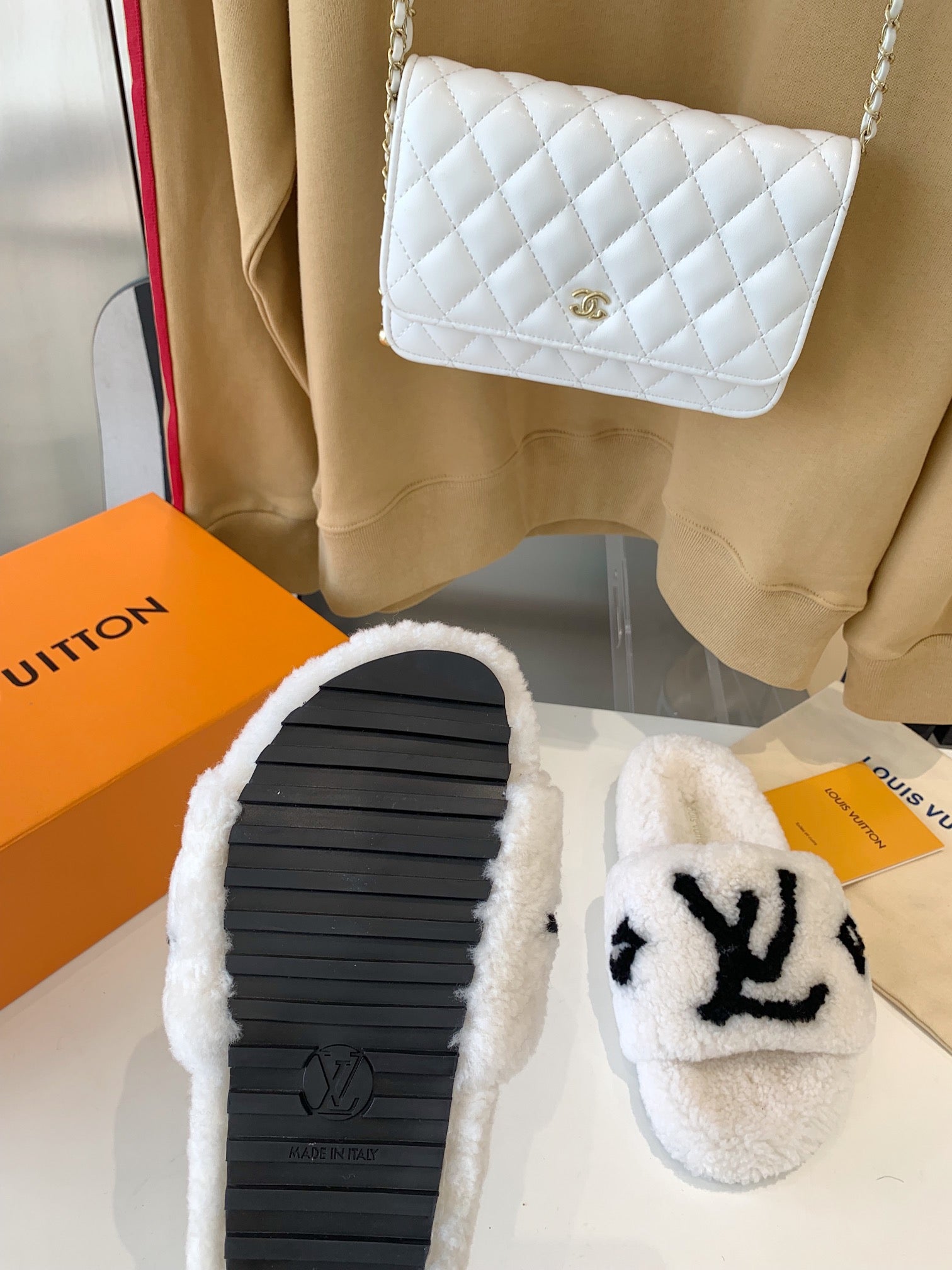 LOUIS VUITTON LV WOMEN'S PASEO FLAT SLIPPER IN WHITE FLEECE WITH BLACK LOGO