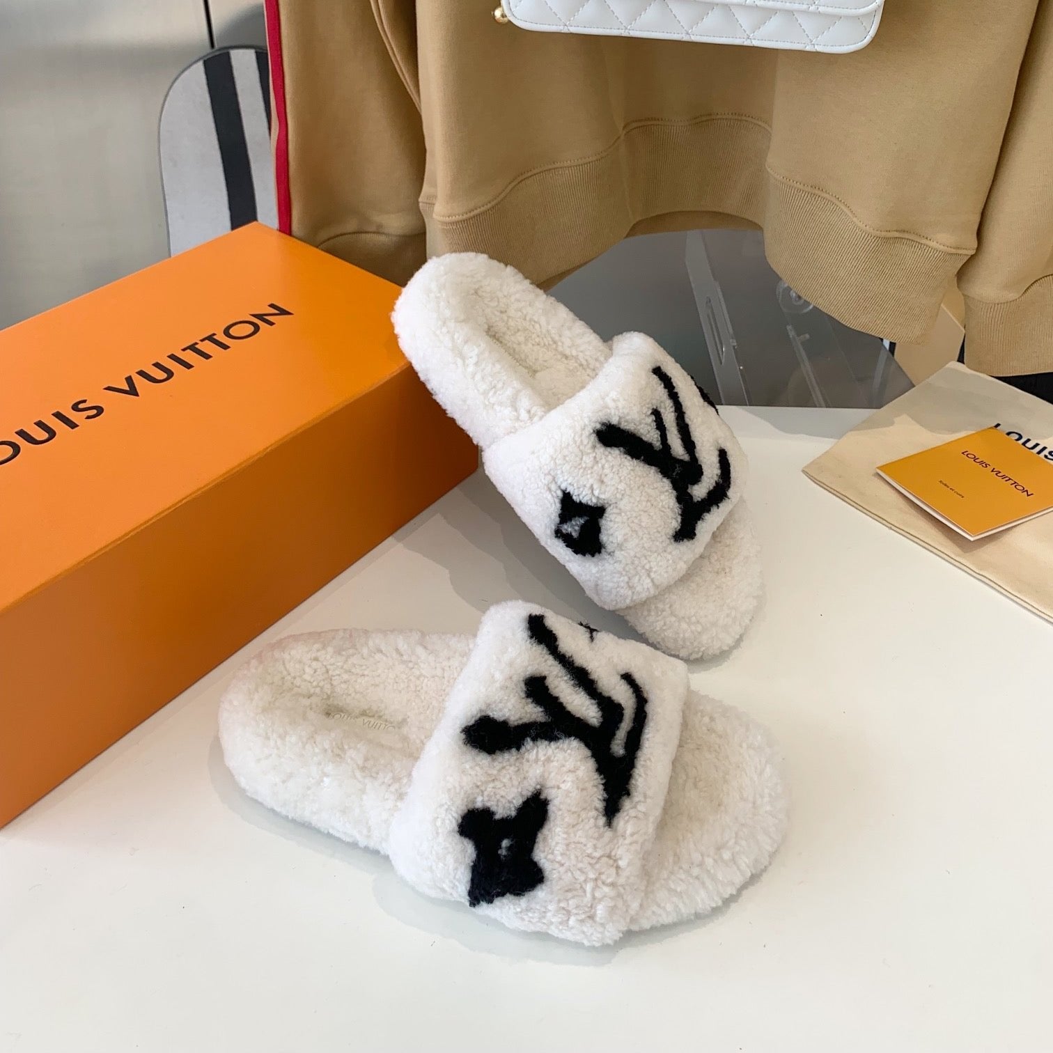 LOUIS VUITTON LV WOMEN'S PASEO FLAT SLIPPER IN WHITE FLEECE WITH BLACK LOGO