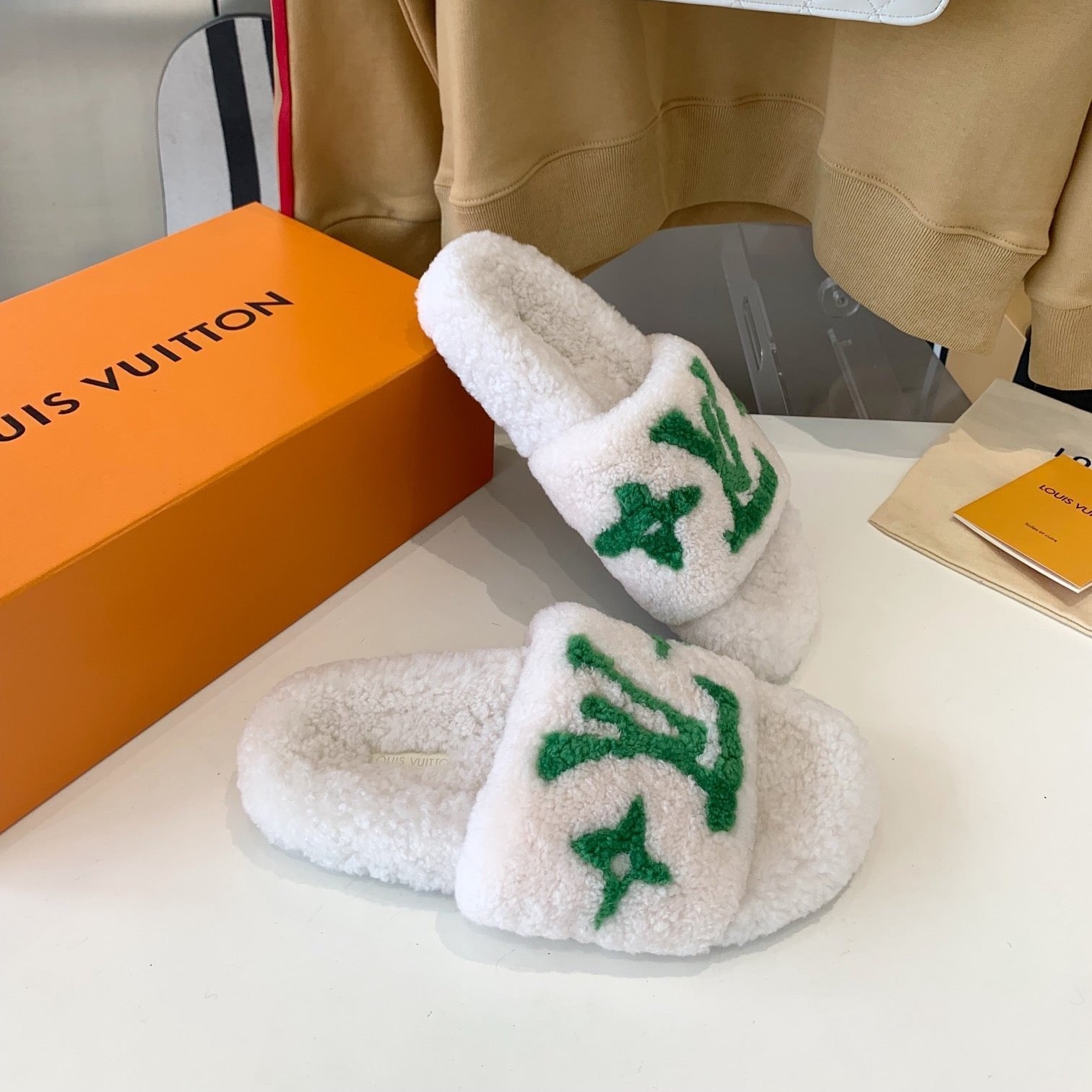 LOUIS VUITTON LV WOMEN'S PASEO FLAT SLIPPER IN WHITE FLEECE WITH GREEN LOGO