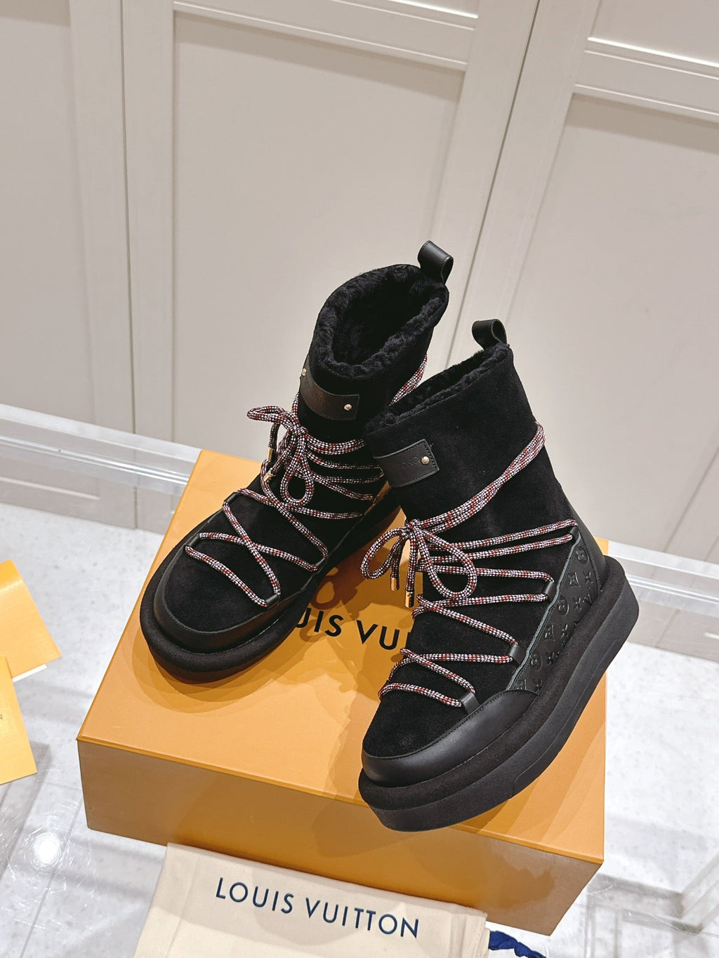 LOUIS VUITTON ASPEN PLATFORM ANKLE BOOT IN BLACK MONOGRAM DEBOSSED SUEDE AND SHEARLING
