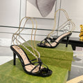GUCCI STRAPPY SANDAL WITH RHINESTONE CHAIN IN BLACK PATENT LEATHER