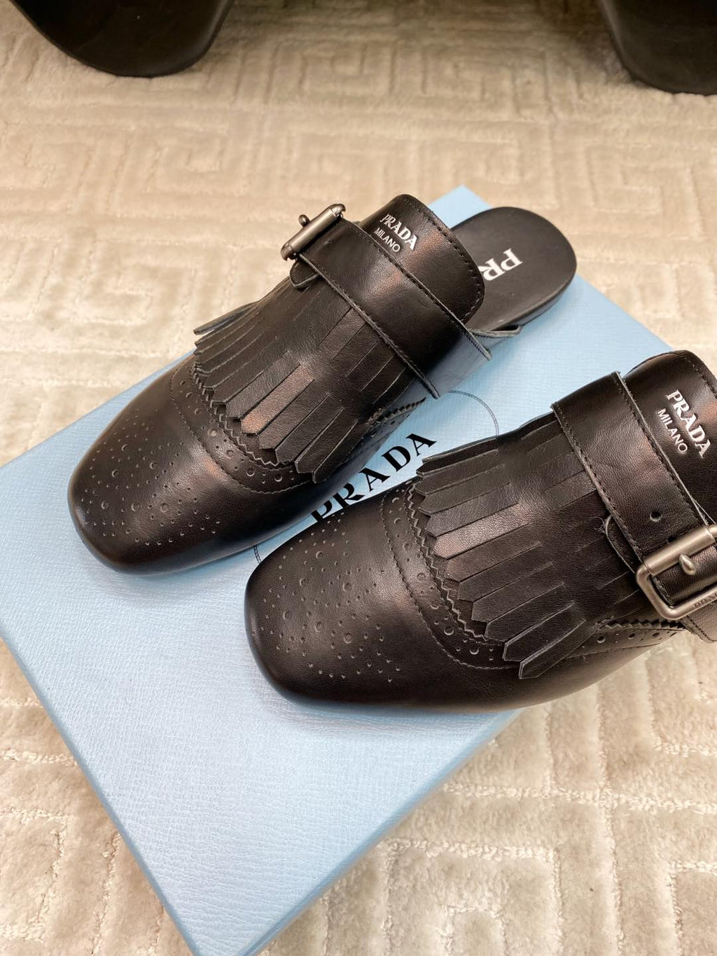 PRADA TASSEL MULES IN BLACK LAMBSKIN