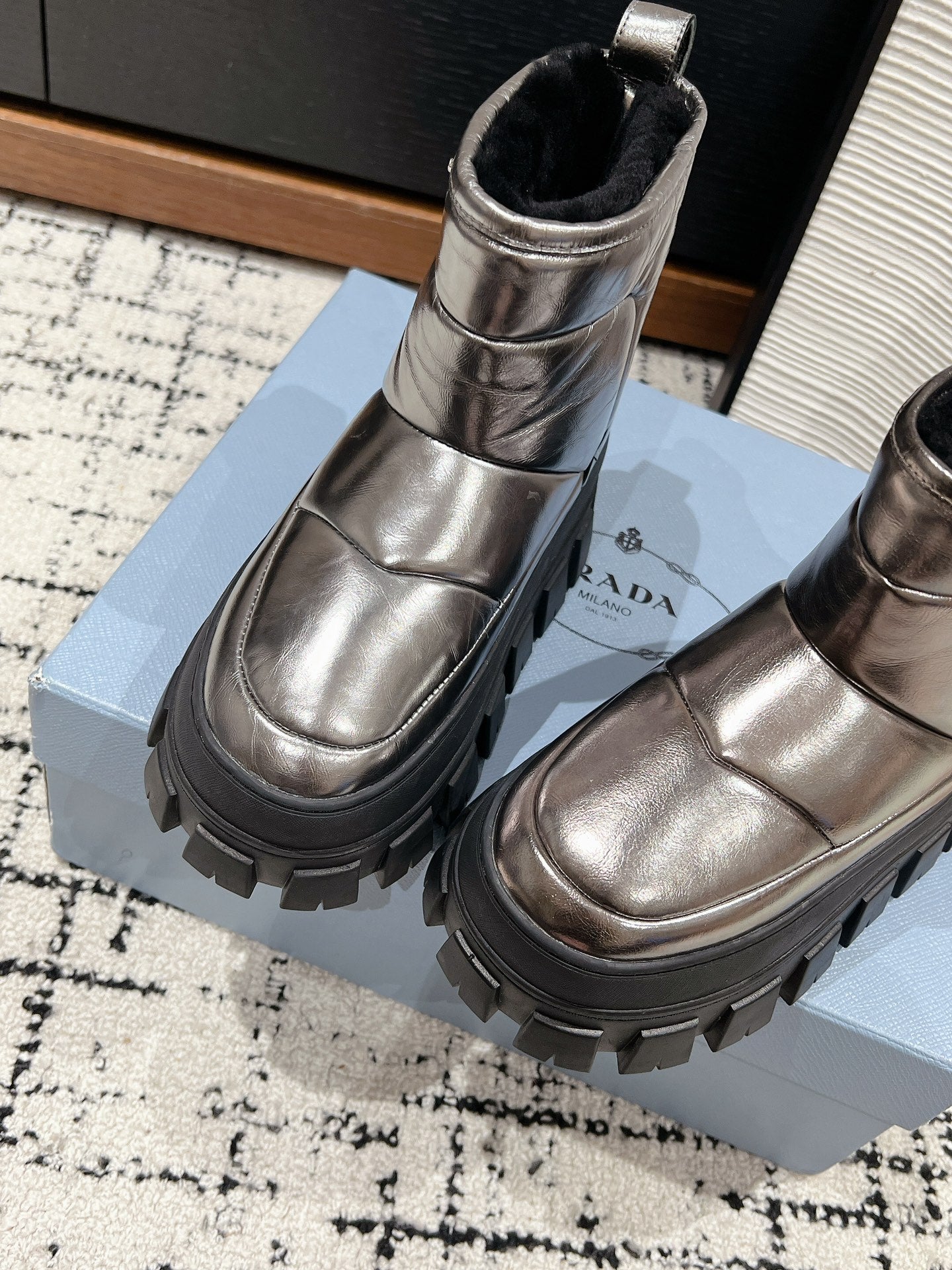 PRADA MONOLITH ANKLE BOOTS IN METALLIC GRAY CALFSKIN AND LAMB FUR LINING
