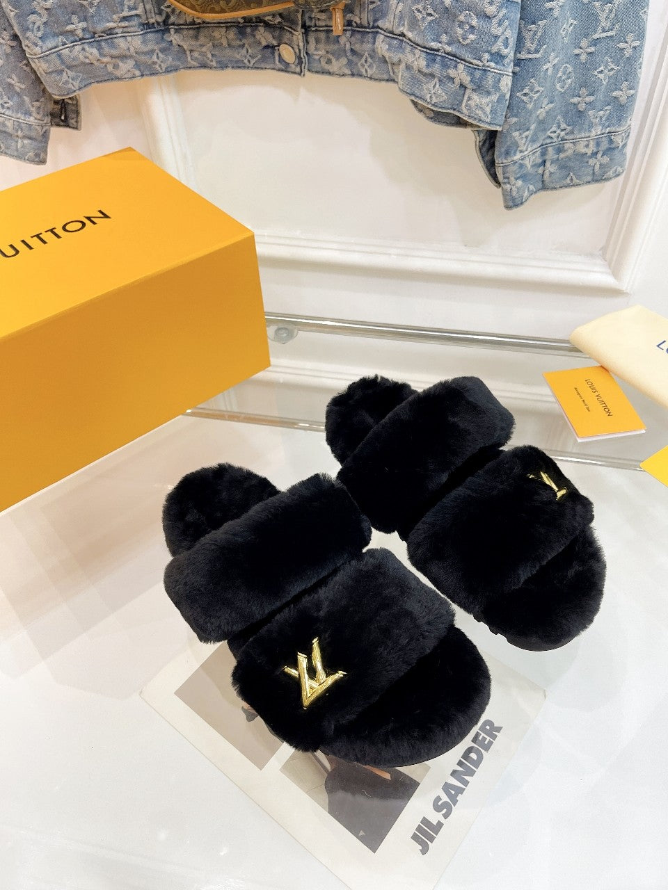 LOUIS VUITTON HALF MULE SLIPPERS IN BLACK FLEECE FEATURING METALLIC LOGO