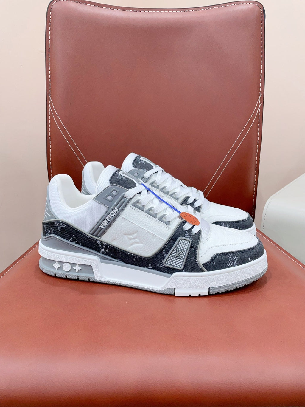 LOUIS VUITTON LV TRAINER SNEAKER IN WHITE CALFSKIN AND BLACK MONOGRAM DENIM