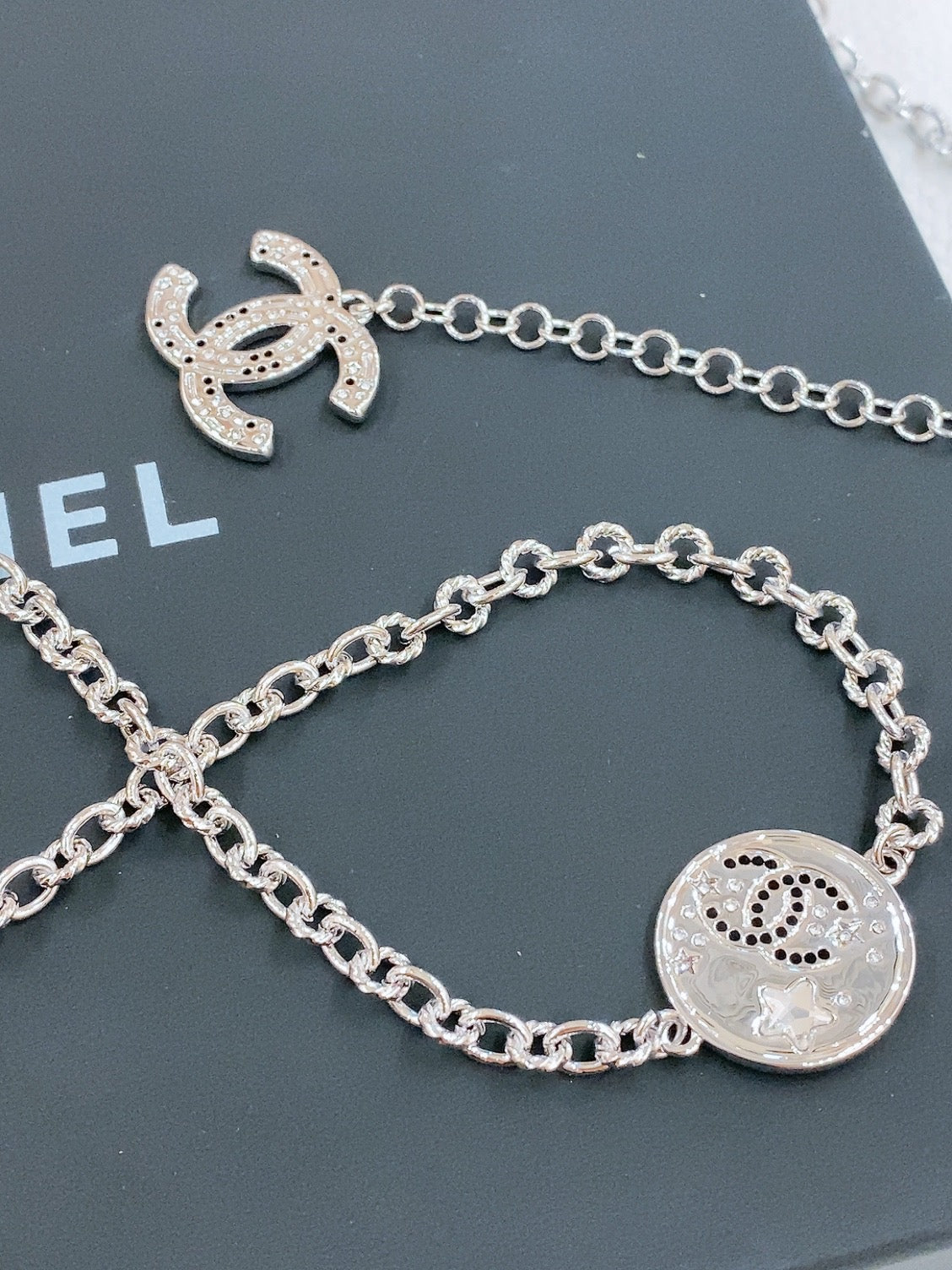 CHANEL TWISTED CHAIN BELT WITH RHINESTONES AND LOGO PLATE IN SILVER TONE